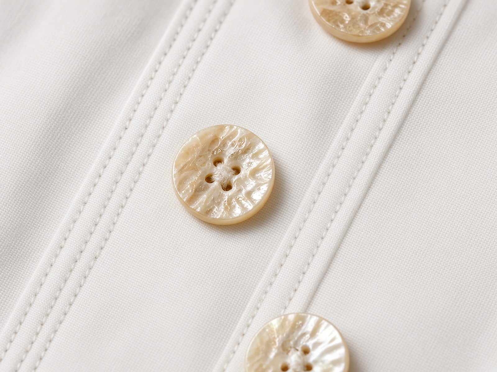 Shell buttons and dense stitching
